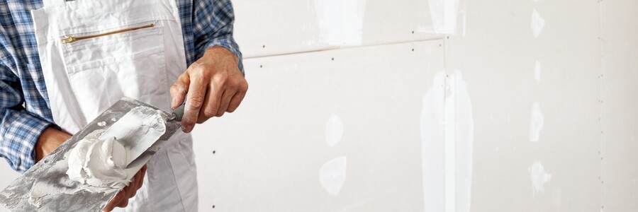 Drywall repair being performed by an experienced Lobos Mechanical LLC drywall technician.